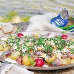 Silltallrik i somrig miljö med Abba matjes, brynt smör, rädisor, gräslök, dill och färskpotatis.